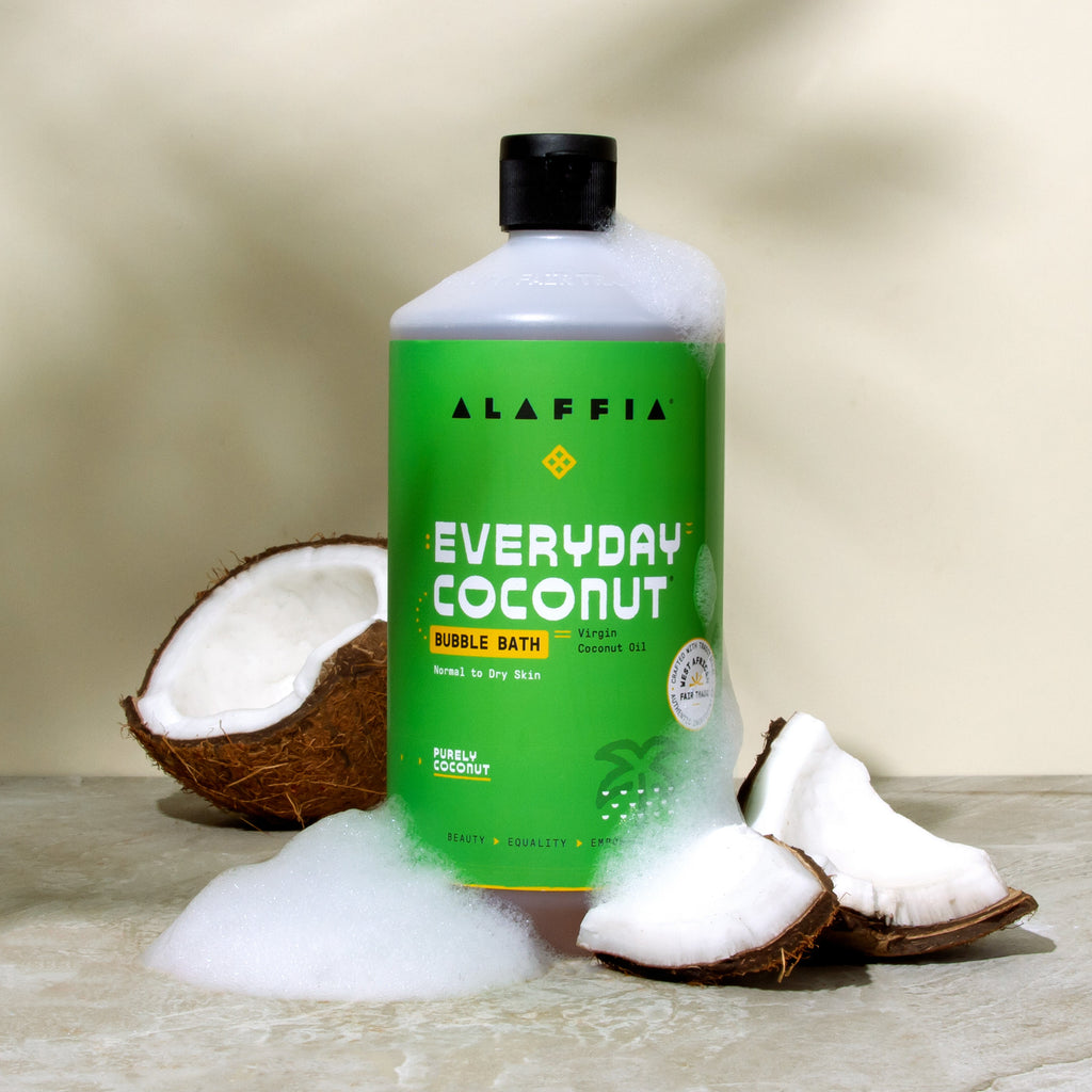 Alaffia coconut bubble bath bottle with coconut shells and white foam