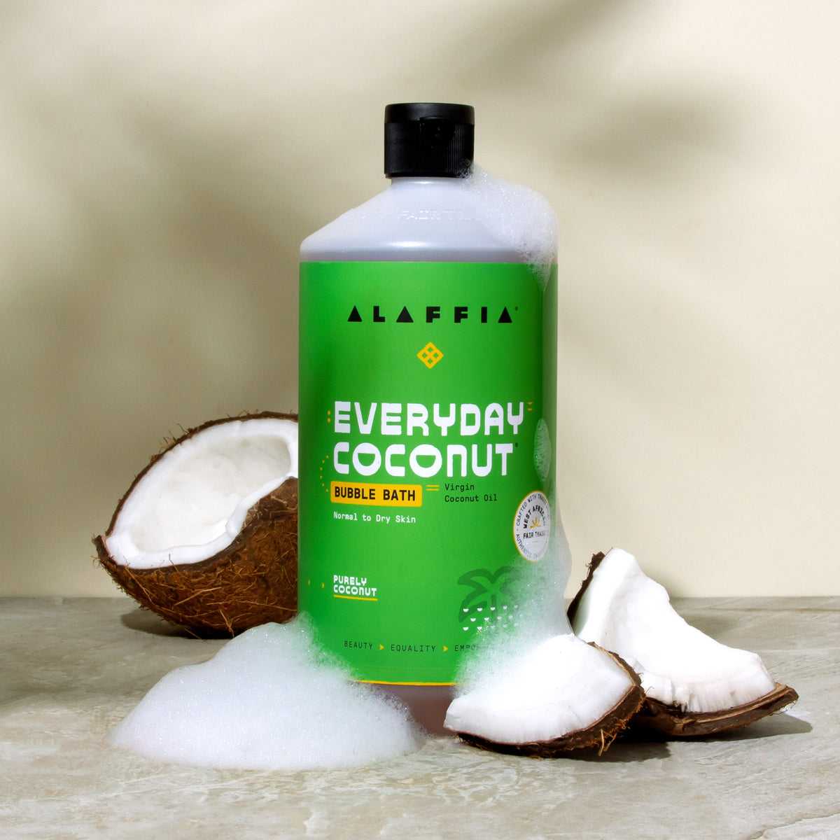 Alaffia coconut bubble bath bottle with coconut shells and white foam