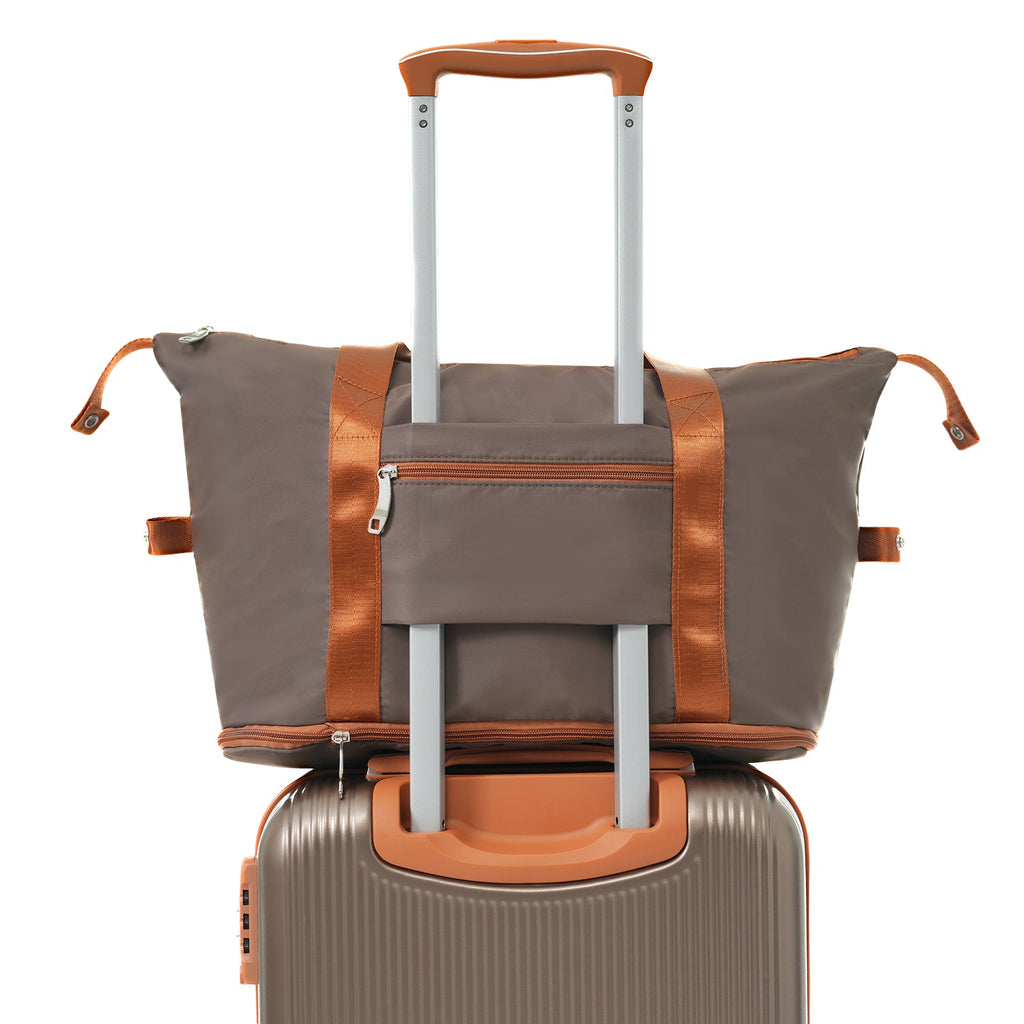 Copper-trimmed hardshell carry-on suitcase with telescoping handle and duffel bag