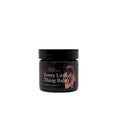 Black herbal balm jar with wide lid and front label artwork