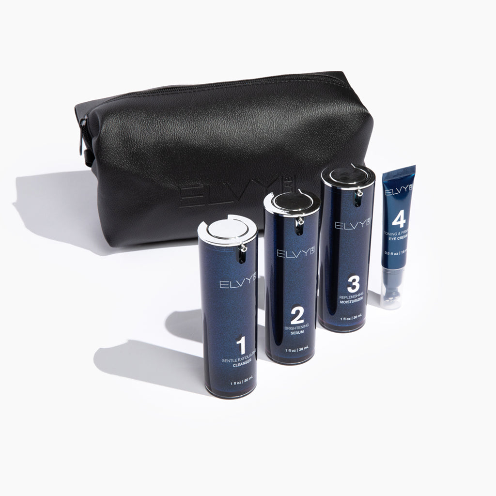 Black leather toiletry bag with zip closure, structured oval shape.