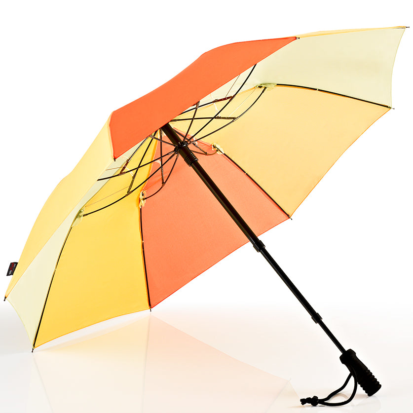 Hands-free trekking umbrella with orange-and-cream panel canopy, telescopic black shaft