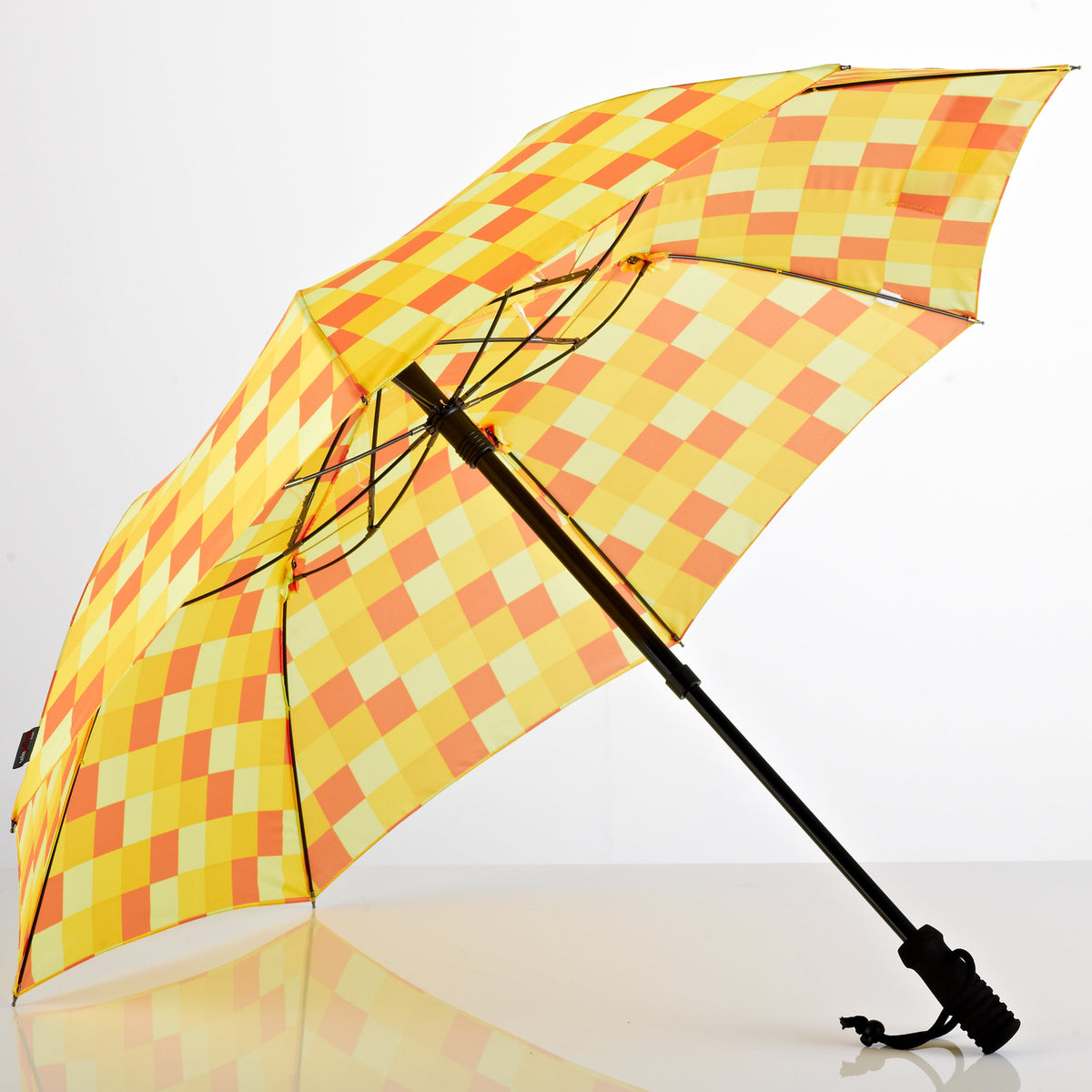 Hands-free trekking umbrella with yellow and orange check canopy, telescopic black shaft