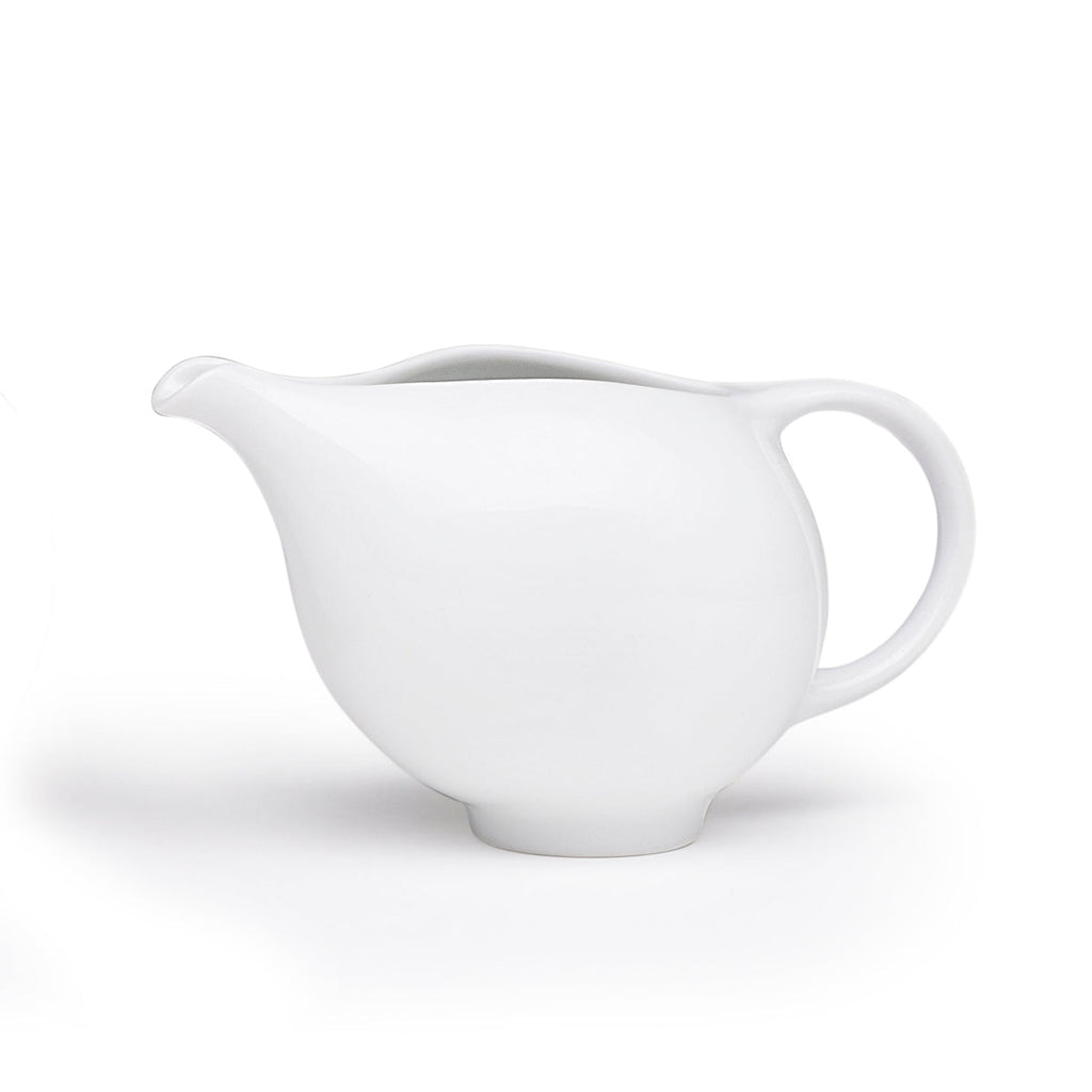 White ceramic creamer pitcher with curved spout and side handle
