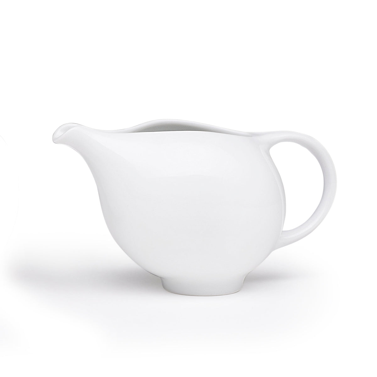 White ceramic creamer pitcher with curved spout and side handle