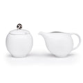 White ceramic sugar bowl with lid and matching creamer, rounded spout and handle