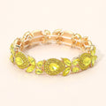 Gold stretch bracelet with teardrop and marquise yellow stone cluster beads