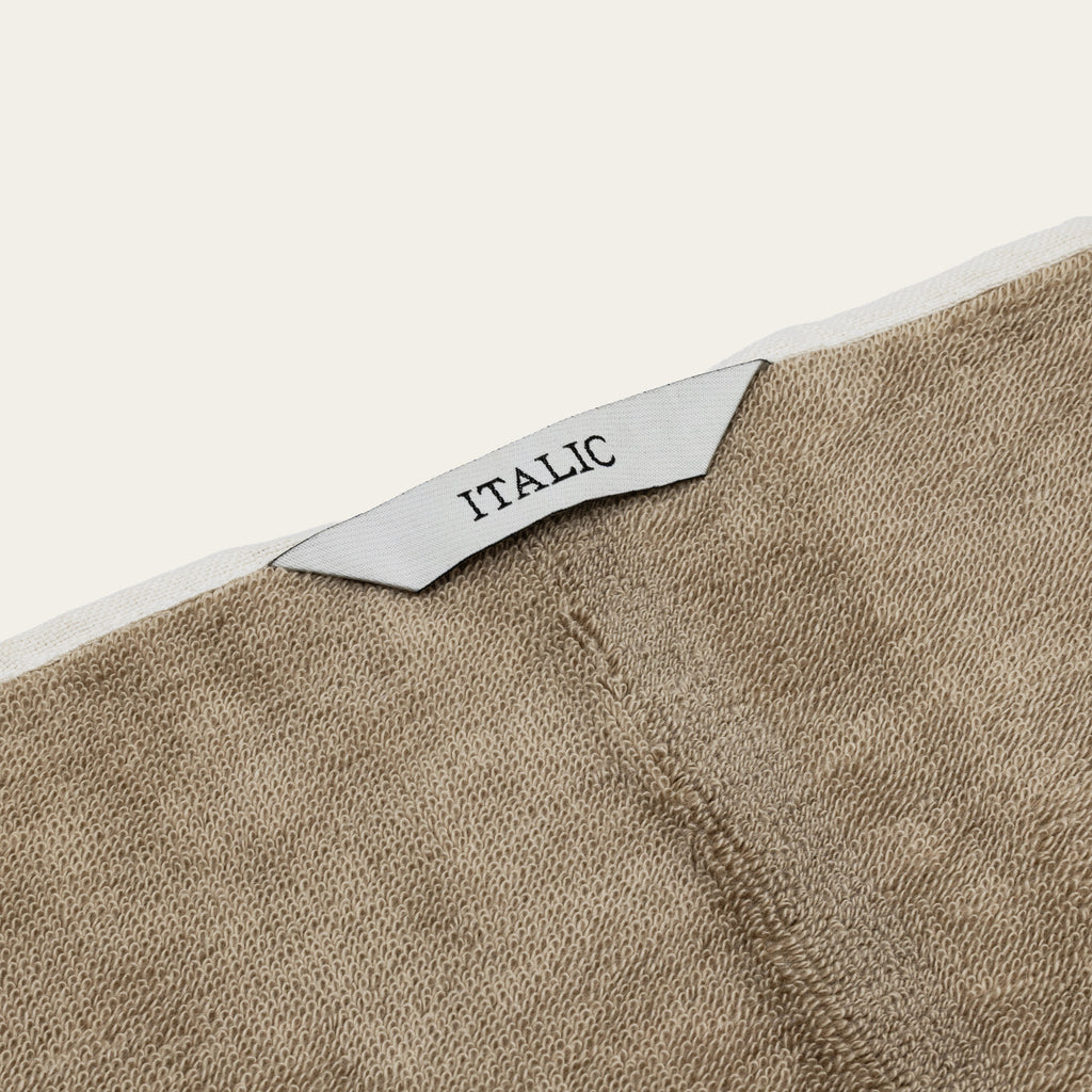 Tan cotton towel corner with textured weave and ITALIC label