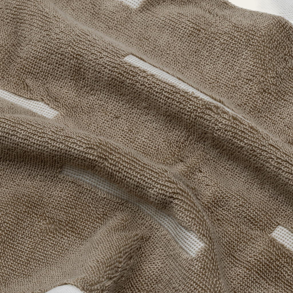 Tan cotton towel fabric with ecru stripe detail and textured looped weave