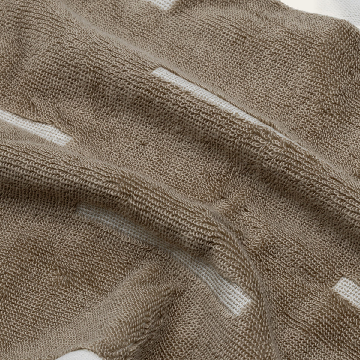 Tan cotton towel fabric with ecru stripe detail and textured looped weave