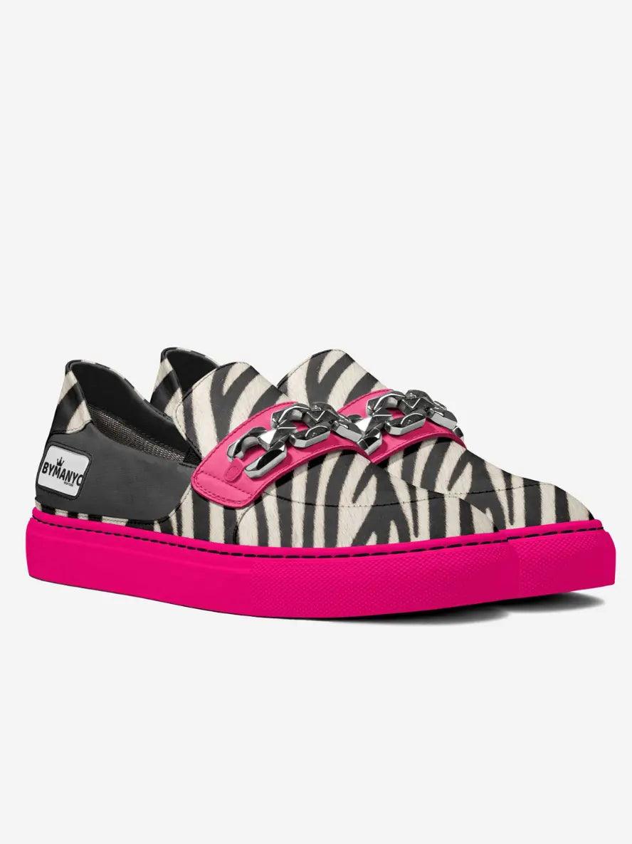 Zebra-print low-top sneaker with pink buckle straps and bright pink sole