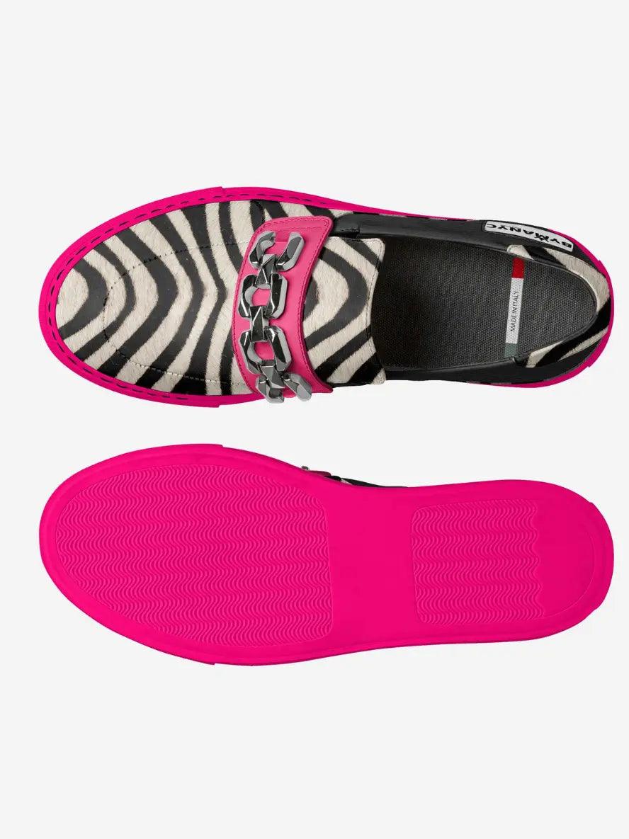 Side view of zebra-print sneaker with pink trim and textured rubber outsole