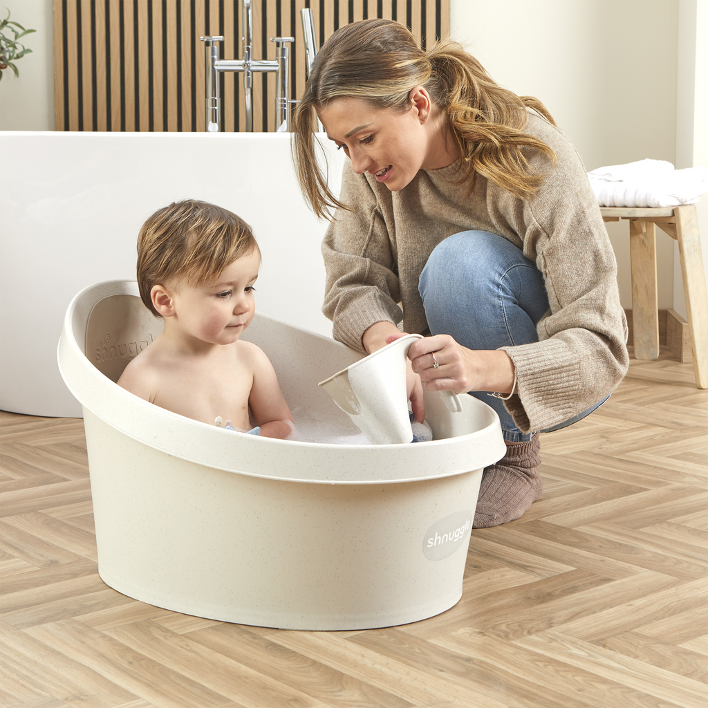 Toddler bath tub with child seated and backrest insert