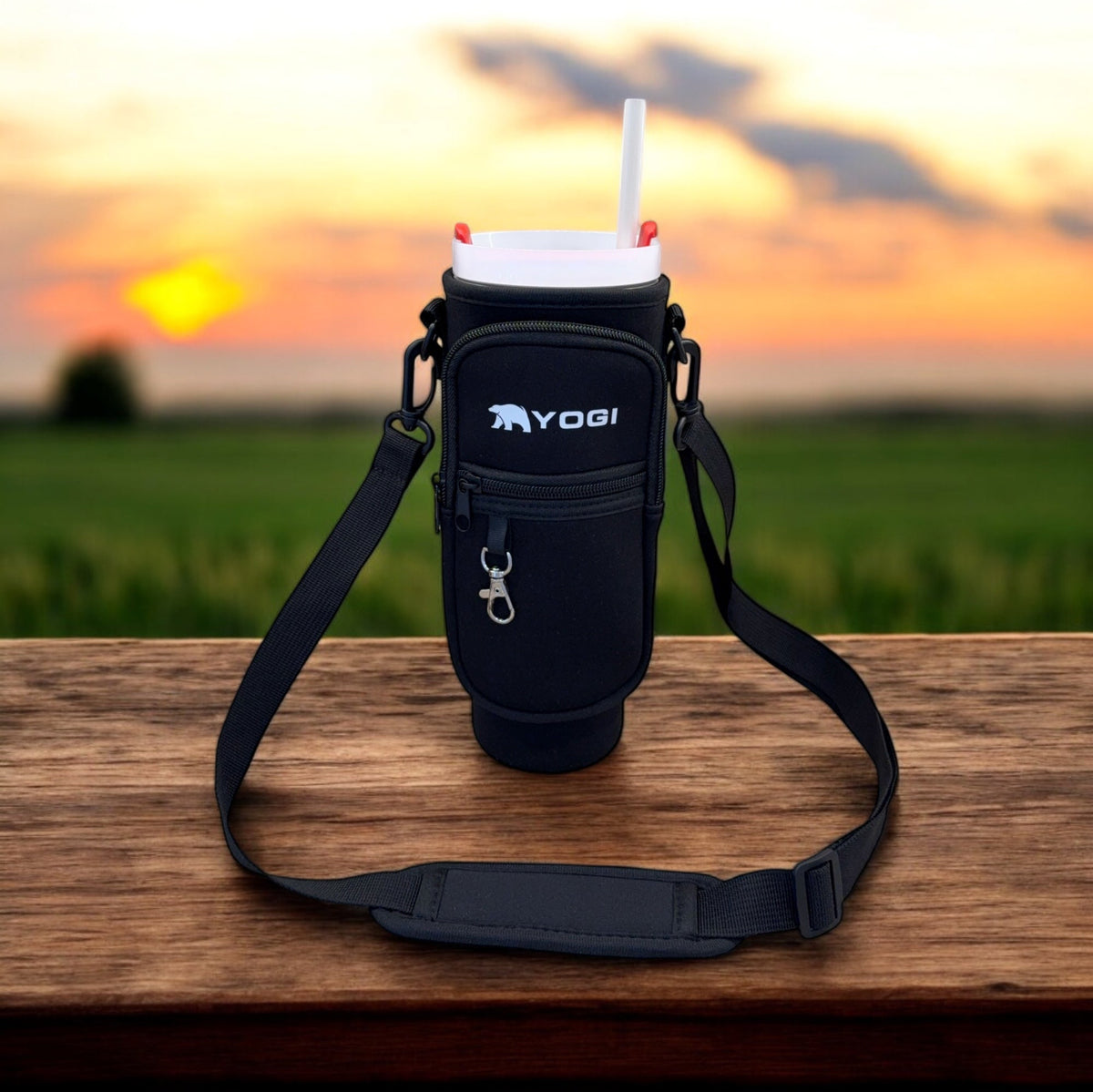 Black crossbody tumbler tote with front zip pocket and adjustable shoulder strap