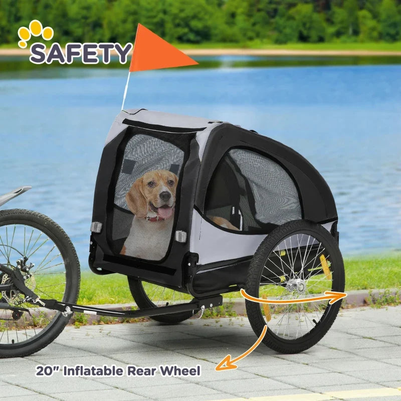 Black dog bike trailer with mesh windows, red safety flag, and 20-inch rear wheel