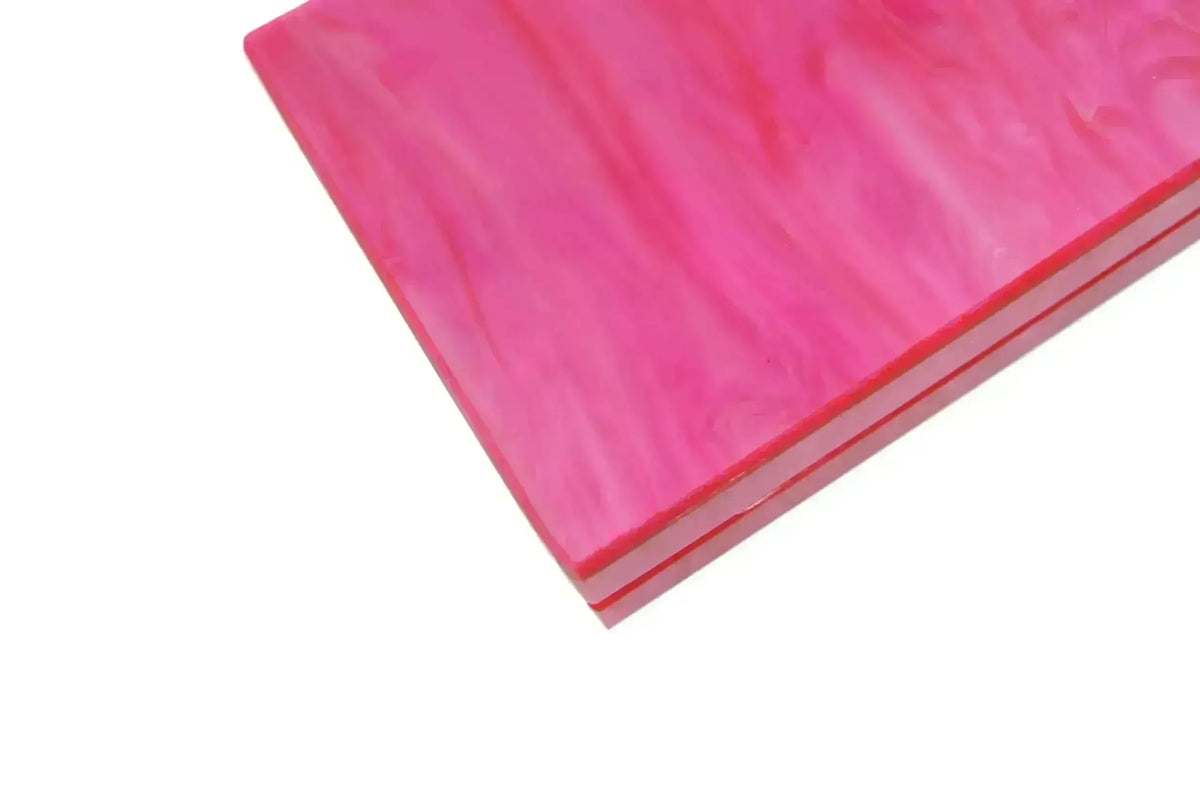 Pink acrylic clutch corner with glossy marbled texture and thin border