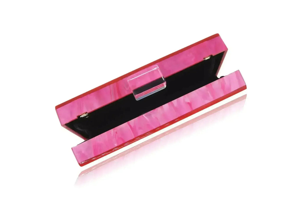 Pink acrylic box clutch open to black interior with silver clasp