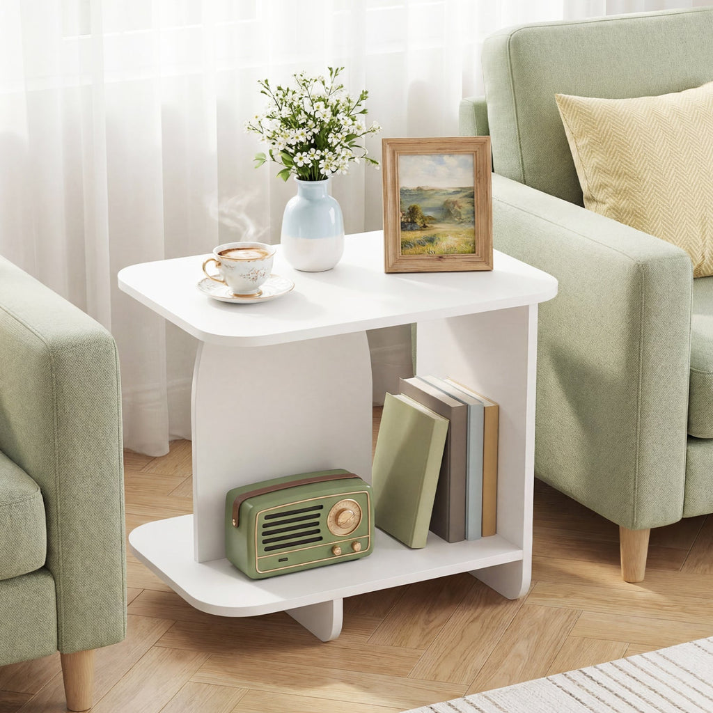 White 2-tier end table with open lower shelf, holding books and small decor