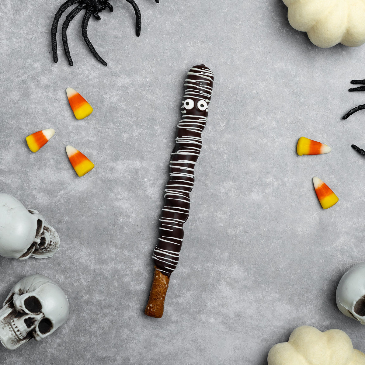 Halloween dark chocolate mummy pretzel rod with white stripe bandage details