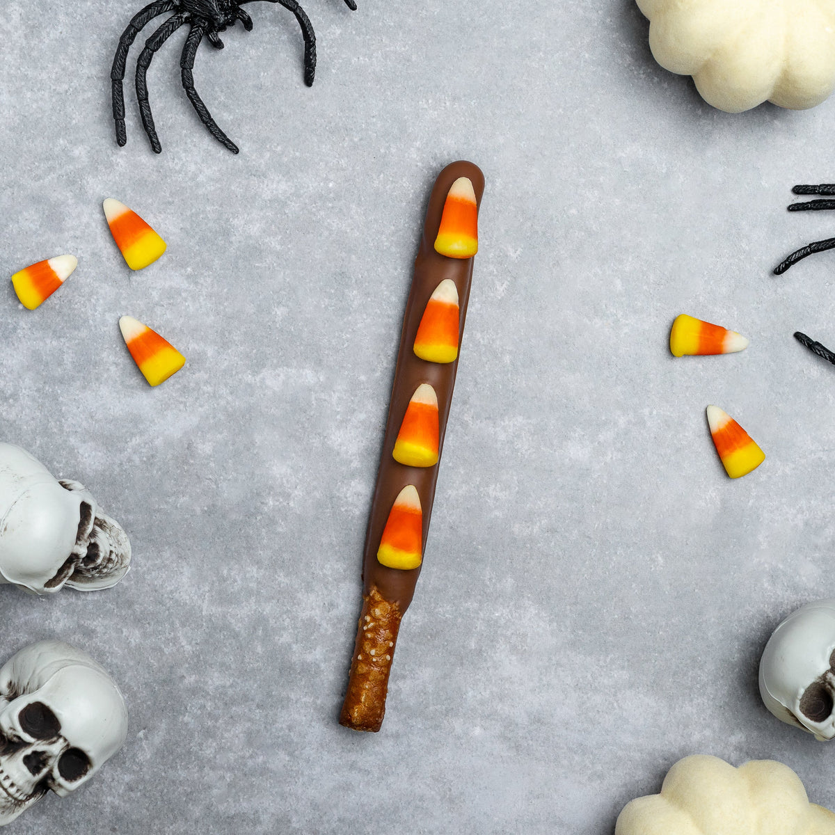 Candy corn–topped pretzel rod with orange, yellow, and white candy coating