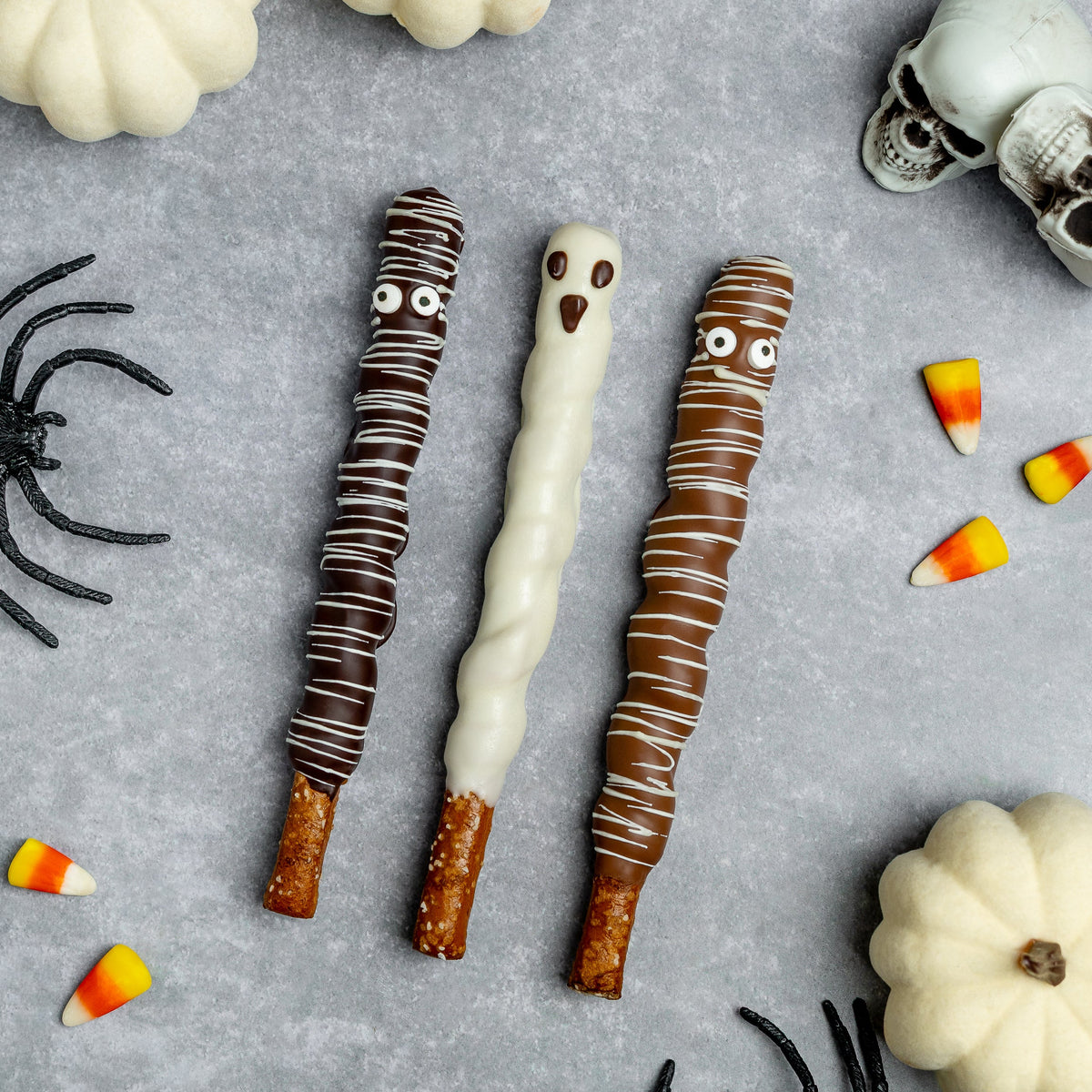 Halloween chocolate pretzel rods: dark mummy, white ghost, and caramel-brown mummy rods