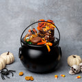 Halloween cauldron basket with orange ribbon and candy assortment