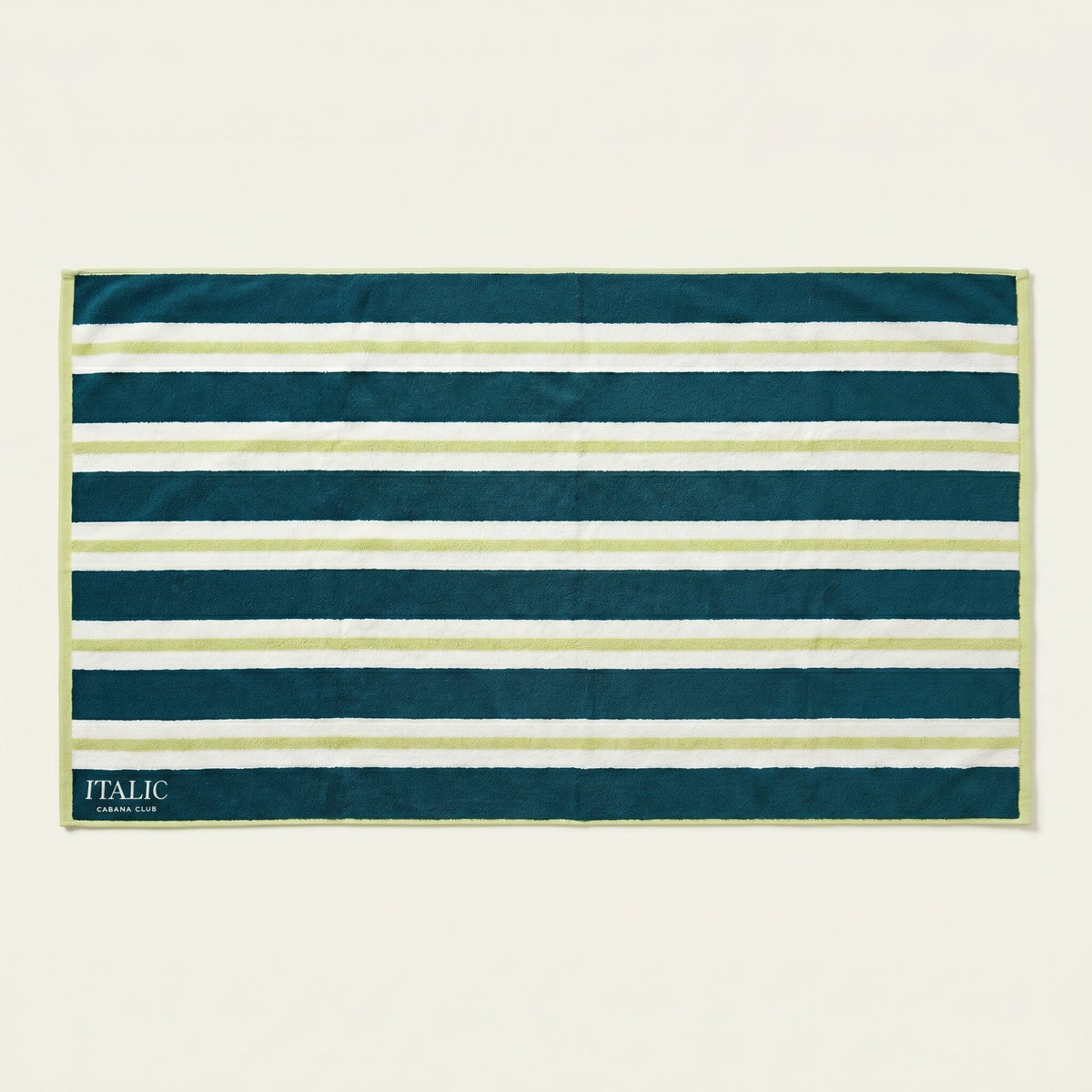 Cotton beach towel with teal, navy, and white horizontal stripes and “ITALIC” label