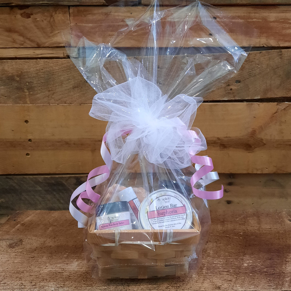 Small scented gift set basket in clear wrap with pink ribbons and lotion bar