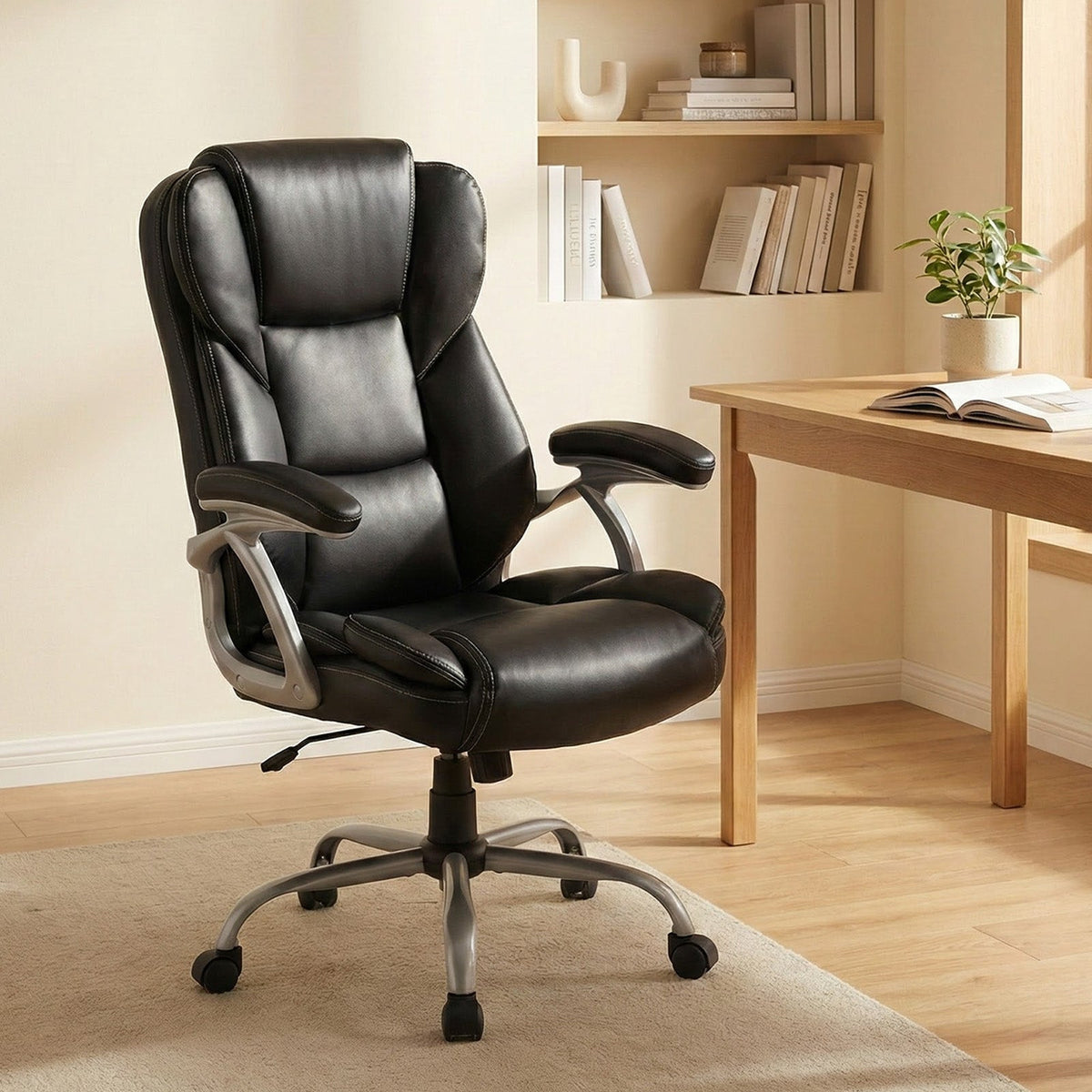 Black leather executive office chair with padded seat, tall backrest, and armrests