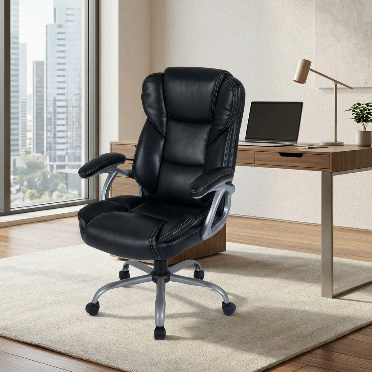 Black leather executive office chair with high back, padded armrests, and five-caster base.