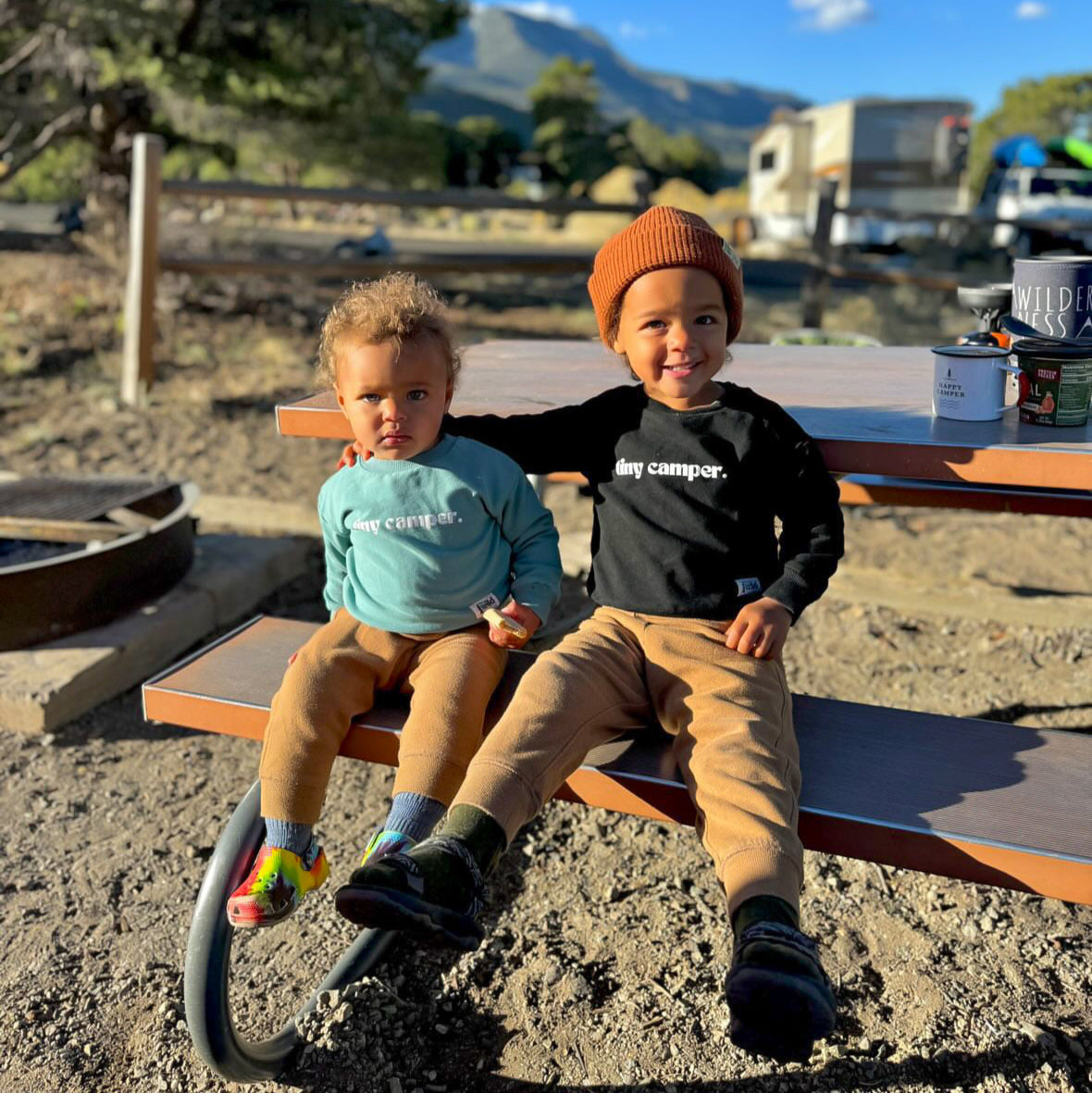Teal long-sleeve crewneck pullover on a child, with ribbed cuffs and hem.