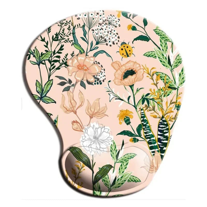 Ergonomic mouse pad with wrist rest, light pink floral print with green leaves and yellow accents