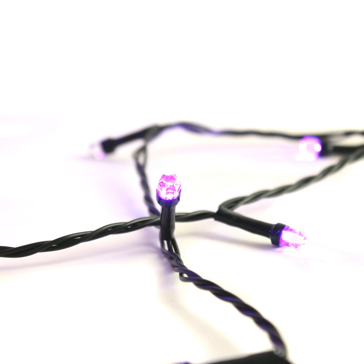 Purple LED string light bulbs along black wire strand, glowing in close-up
