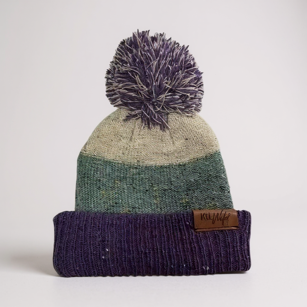 Purple knit puff beanie with pompom and ribbed cuff