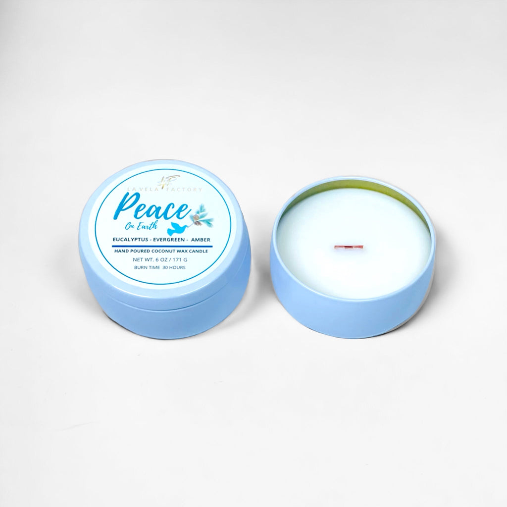 Wood-wick candle in blue tins; lid labeled Peace with white wax visible.