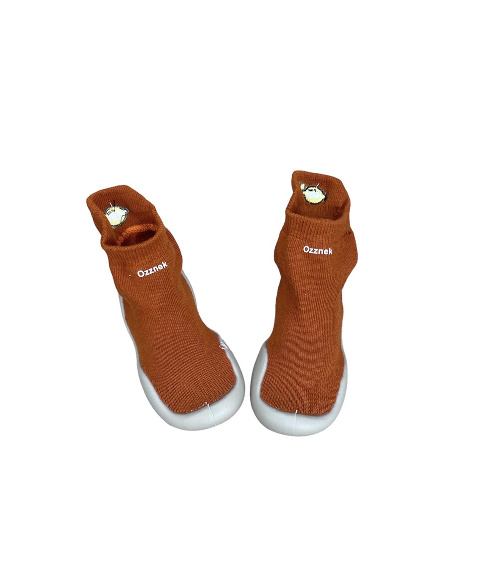 Rust orange sock-style barefoot shoes with owl patch and white protective sole