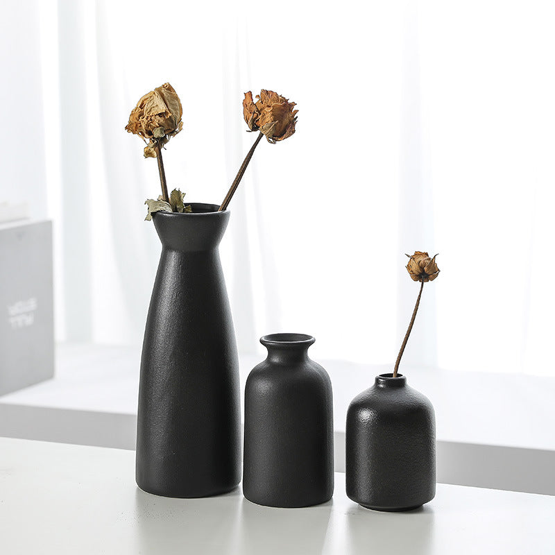 Black ceramic vase decoration set of 3 narrow bottles, one filled with dried flowers