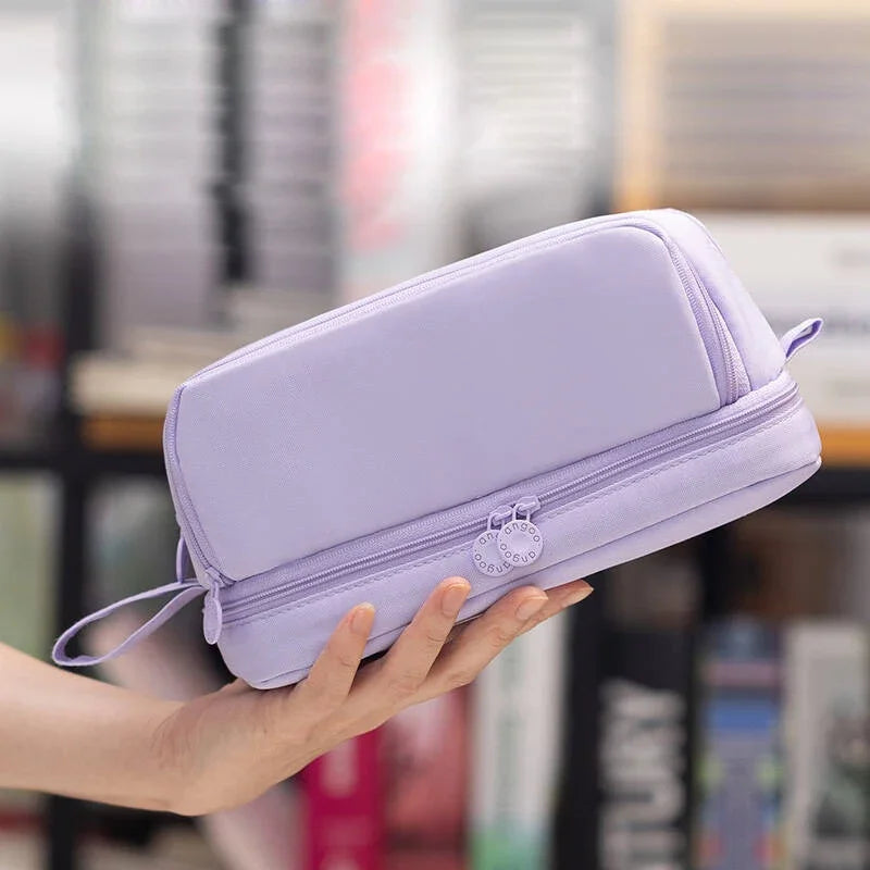 Lavender zippered pencil bag held in hand, with small zipper pull and wrist strap.