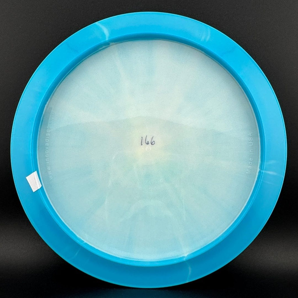Light blue and clear disc golf disc bottom with molded center stamp
