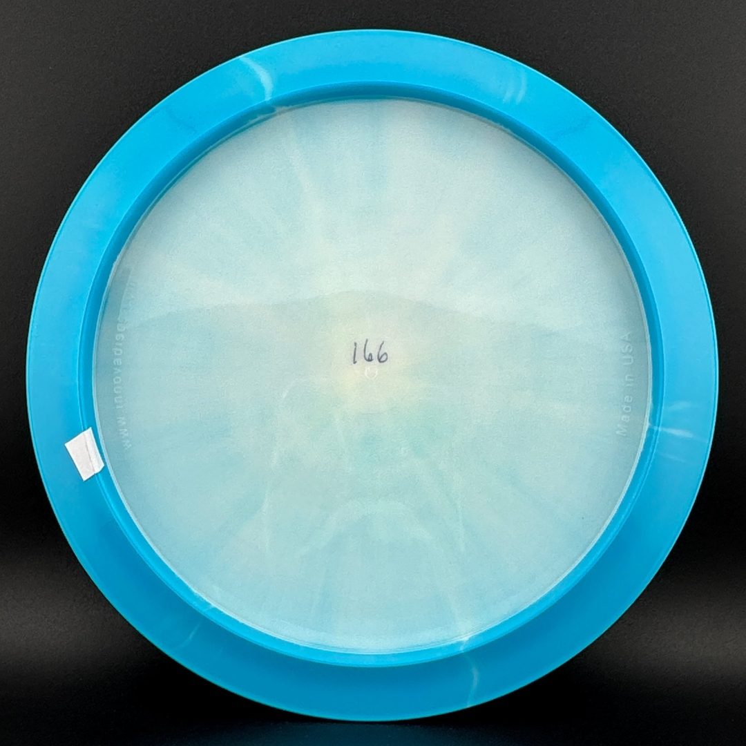 Light blue and clear disc golf disc bottom with molded center stamp