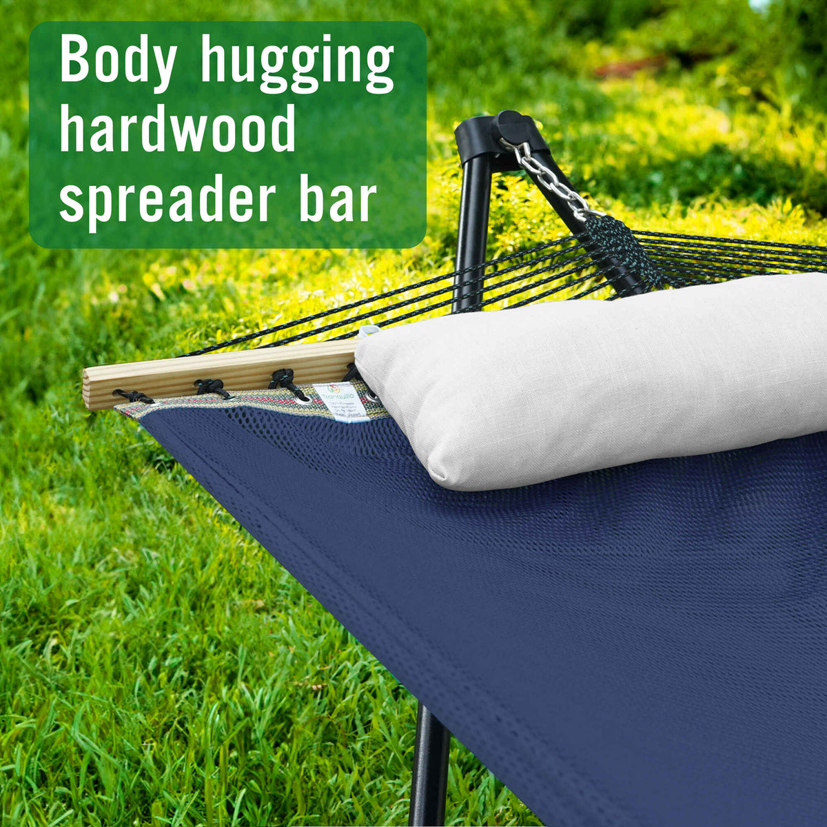 Hammock with stand, navy fabric with off-white pillow and black spreader bar, outdoor-ready