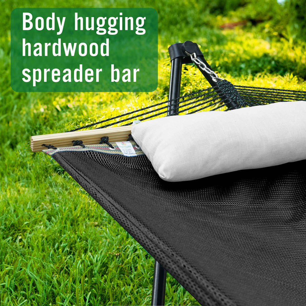 Dark hammock with black stand, beige pillow, and multicolor spreader bar detail
