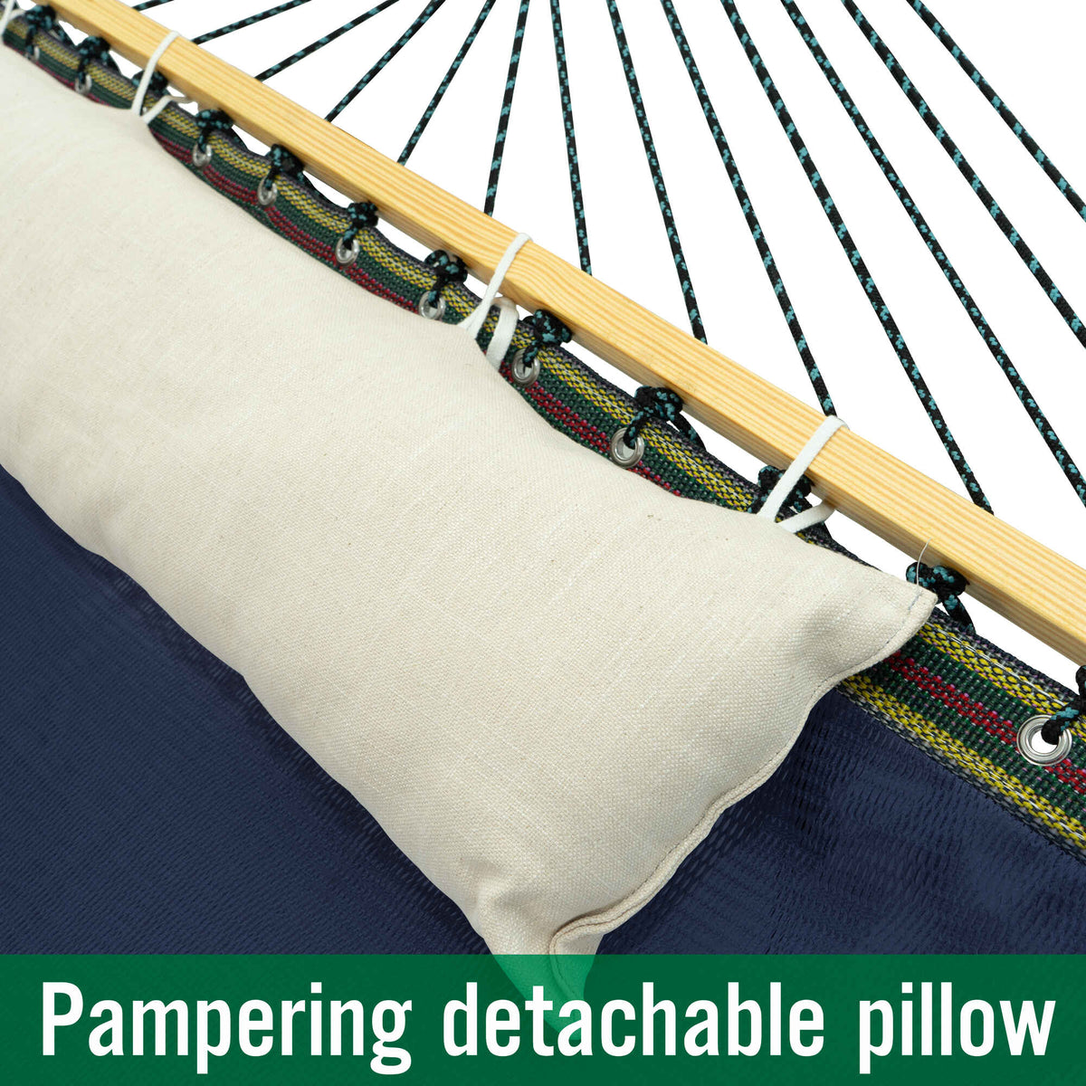 Detachable off-white pillow on navy hammock bed with rope clips and light wood spreader