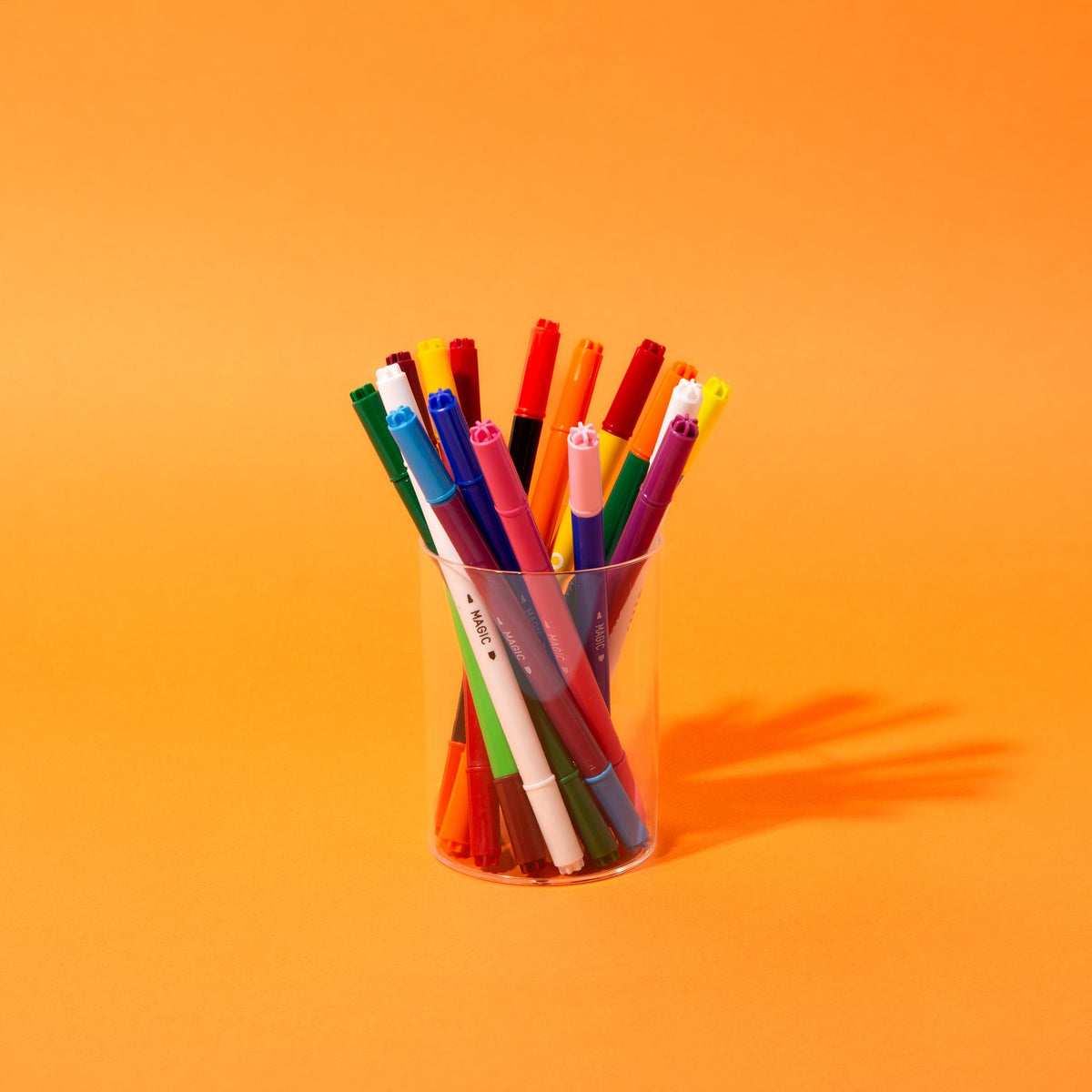 Cup of colorful marker pens, assorted tip colors visible