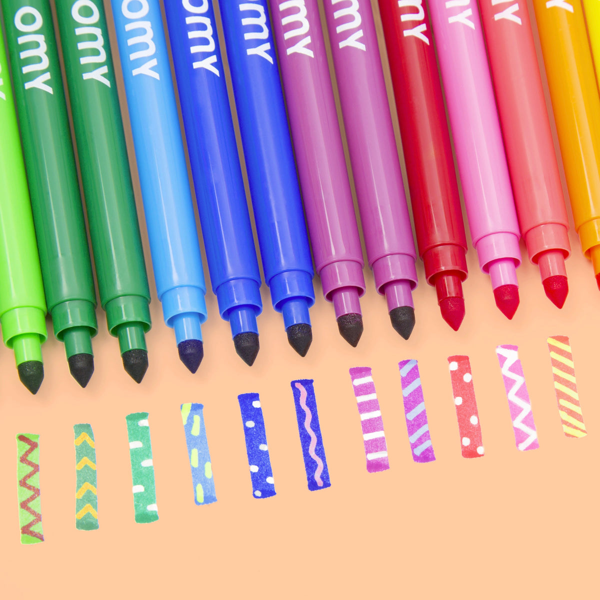 Assorted colored markers with felt tips lined up, multiple ink colors