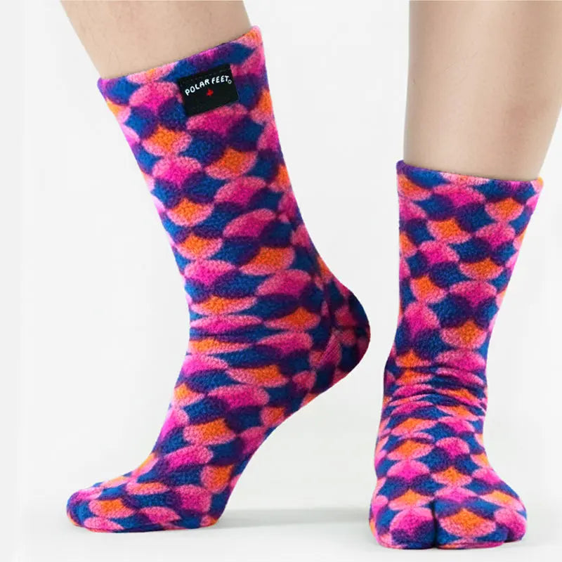 Polar Feet fleece tabi socks on legs, split-toe design in pink, blue, orange diamond pattern.
