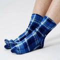Fleece tabi socks in blue plaid, with toe-separation and ribbed cuffs