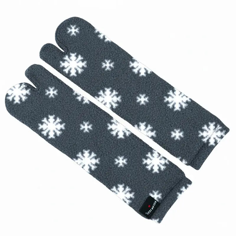 Folded dark gray fleece tabi socks with white snowflake design and split toe