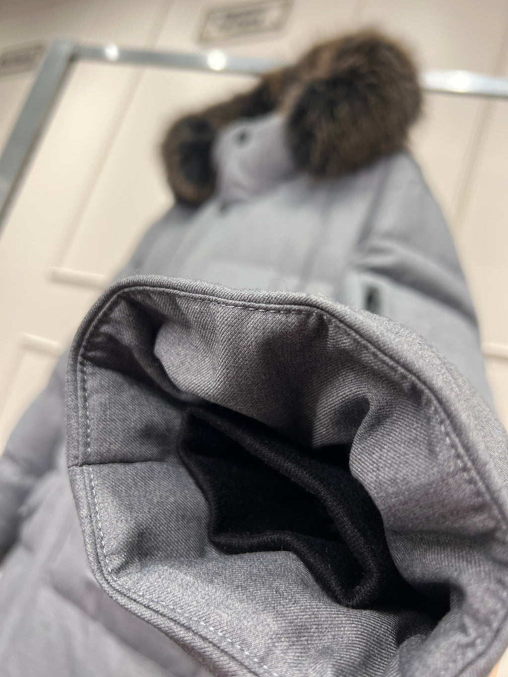 Grey puffer coat hood lining and side pocket opening