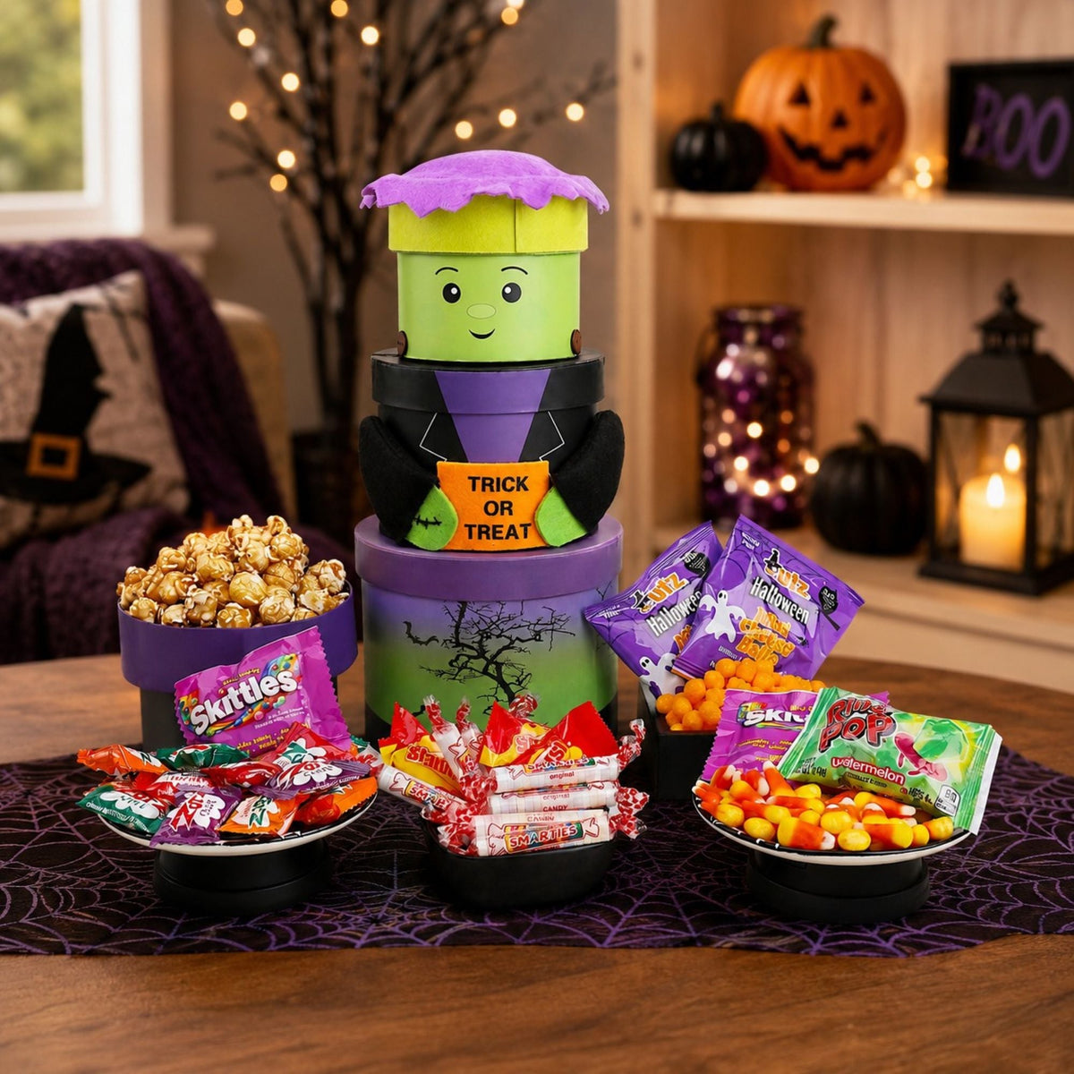 Frankenstein-themed gift tower with green character face, purple roof, and candy cups